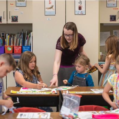 A picture of an individual teaching school-age children