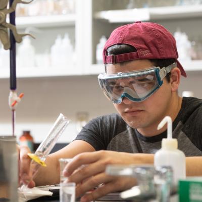 student in goggles in chem lab 