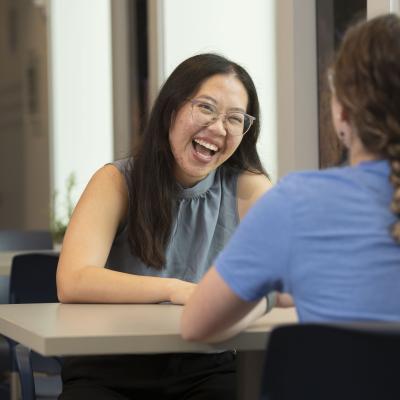 Admissions counselor at a table with a student 