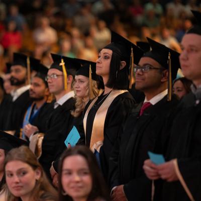 Graduates stand ready to receive their diploma 