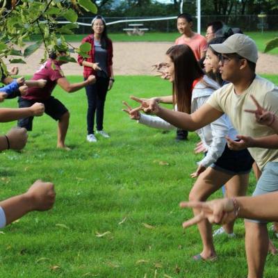 Students in the Hmong living community working together as a group outside