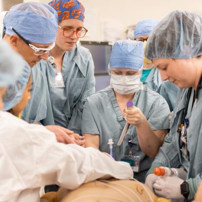 group of medical providers in full scrubs, simulation of code blue