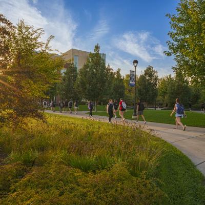 students walking through the Stowe Gateway and Garfield Ave mall on a fall day