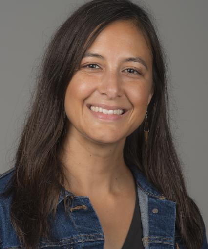 Woman with brown hair smiling.