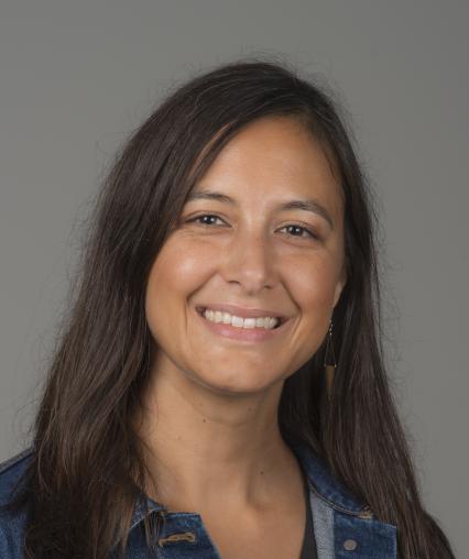 Woman with brown hair smiling.