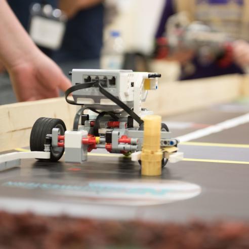 A picture of A robot equipped with sensors navigates a competition track,