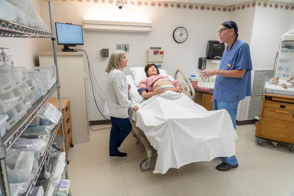Nursing faculty working with new simulation manikin
