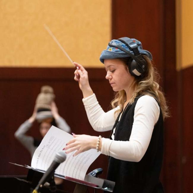student conducting rehearsal