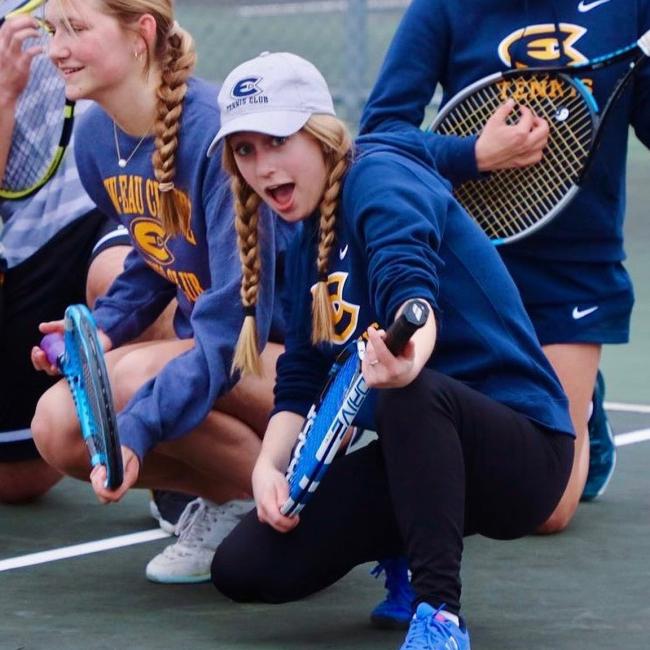 club tennis women silly pose with racquet 