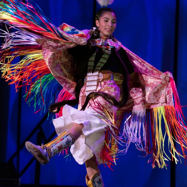 Native American dancer on stage in traditional costume 