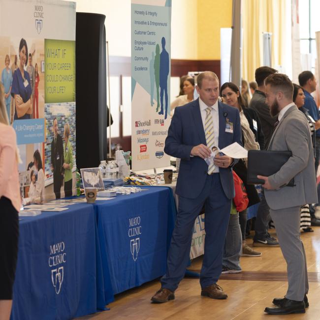 Students talking with an employer at the spring career fair.