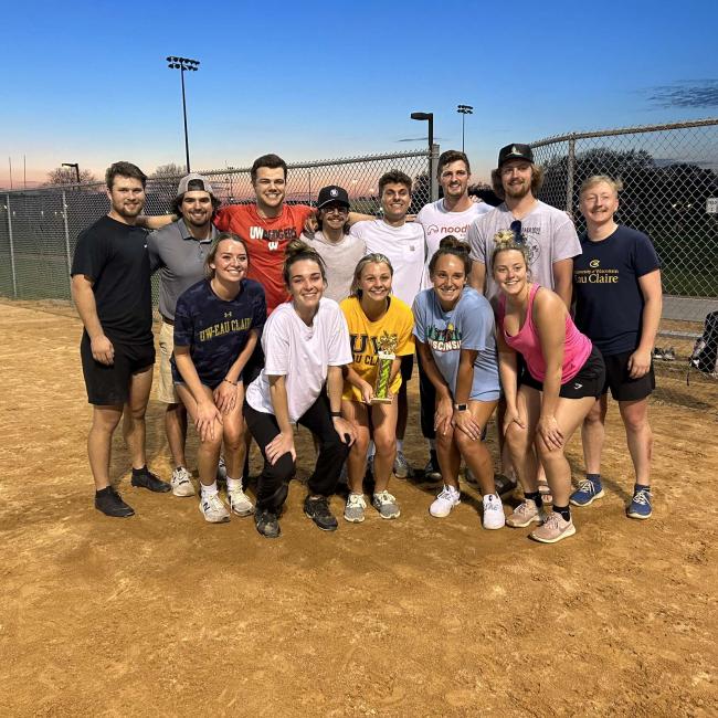 Intramural softball team poses with their trophy