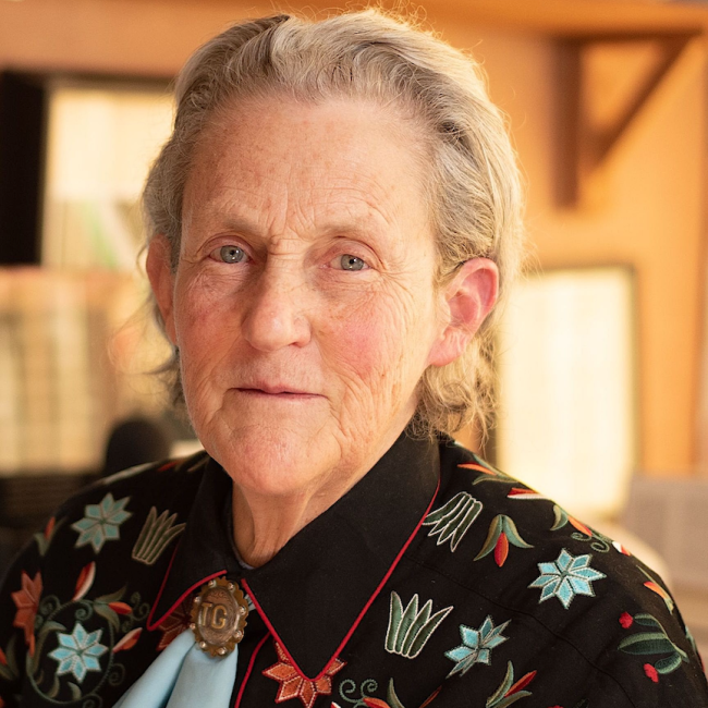 An older woman smiles at the camera. 