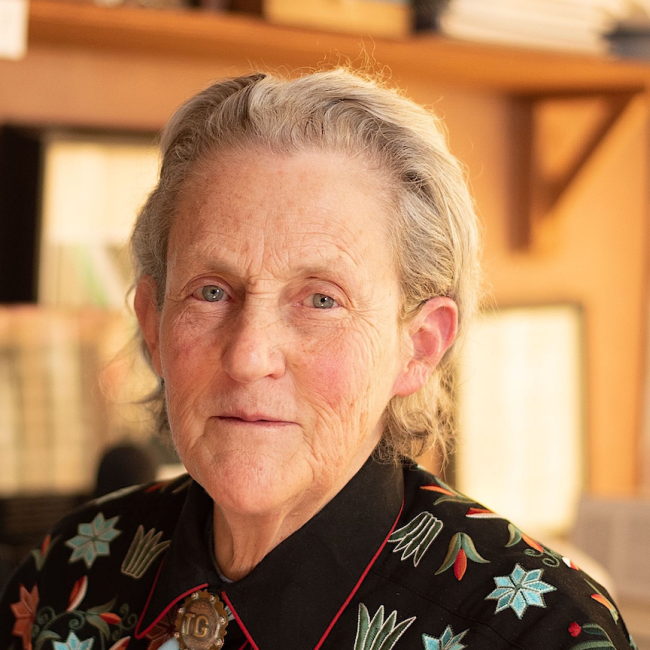 An older woman smiles at the camera. 