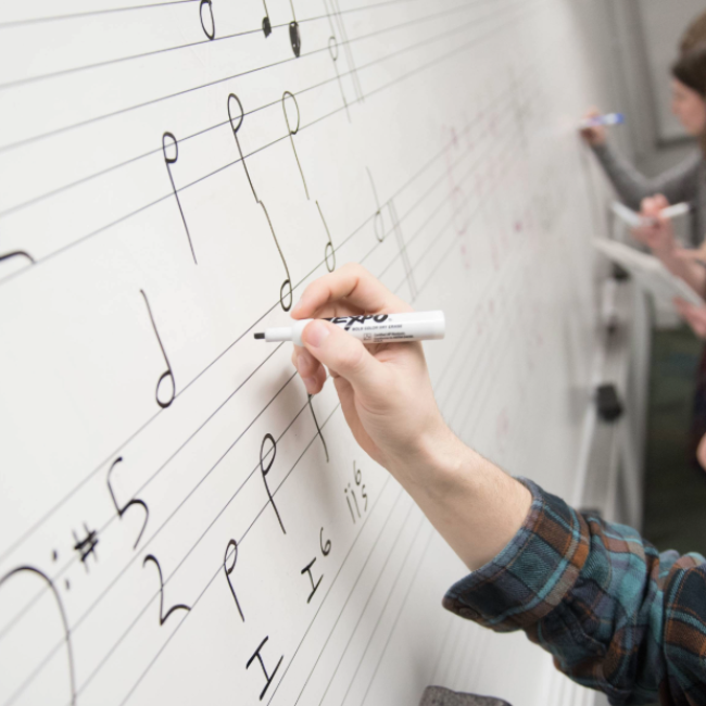 Music theory student writing four-part harmony