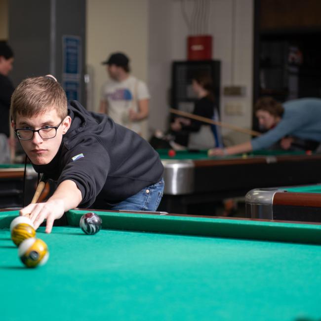 Student playing pool