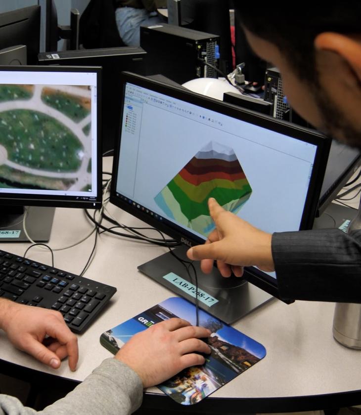 geospatial tech and analysis computers in use by two students 