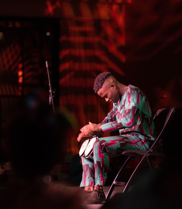 Olu Famule playing drums at celebration