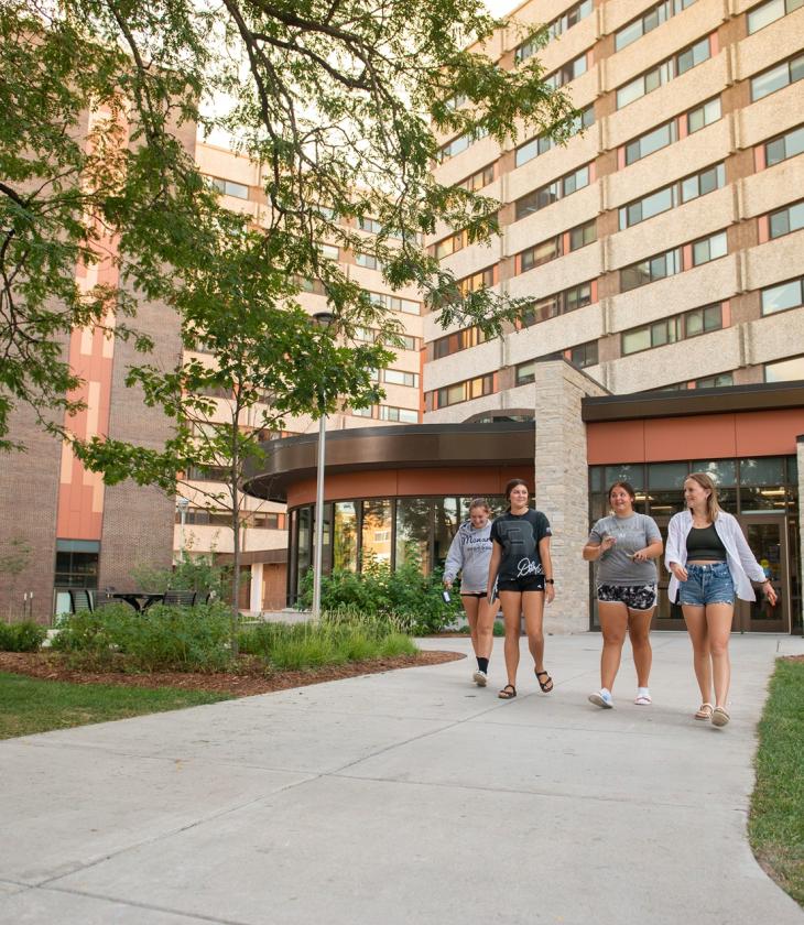 four students walking out of Towers 