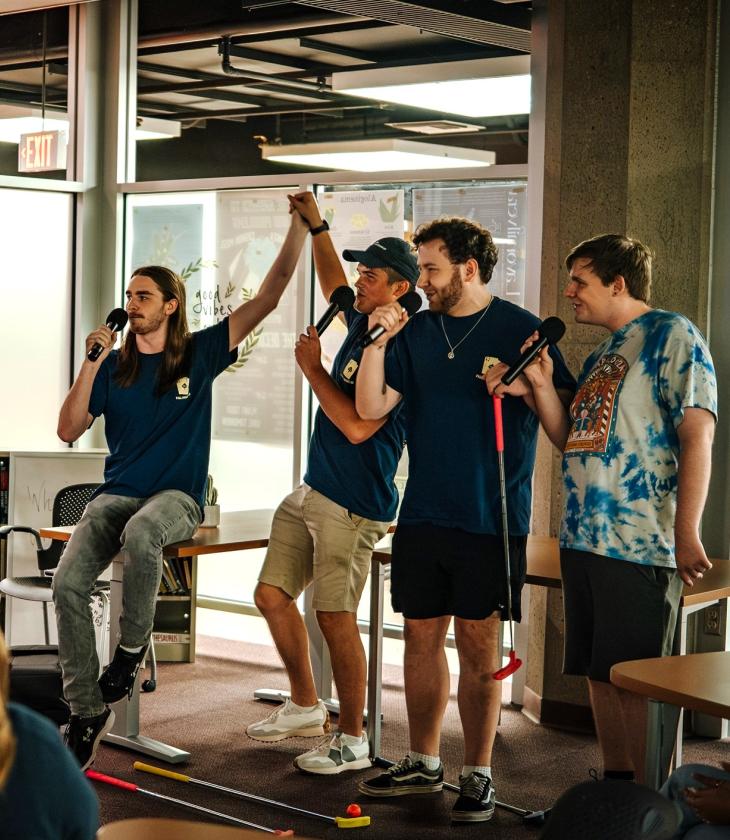 four students singing karaoke