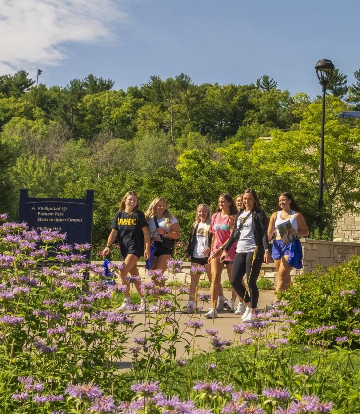 Students walk across the bridge in front of Davies Student Center