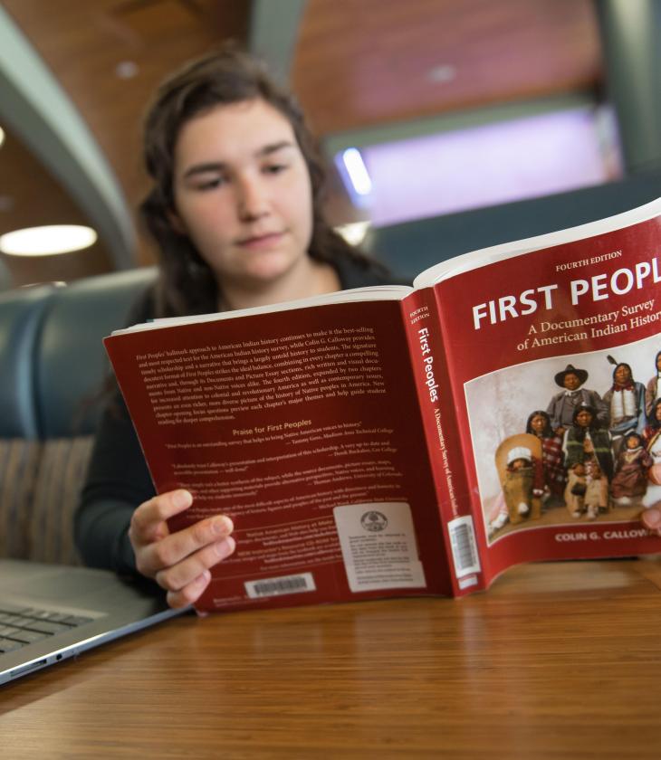 Student reading a textbook