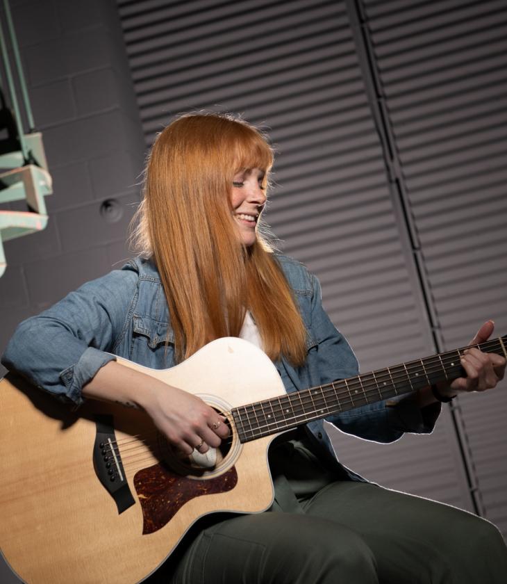 Student playing the guitar