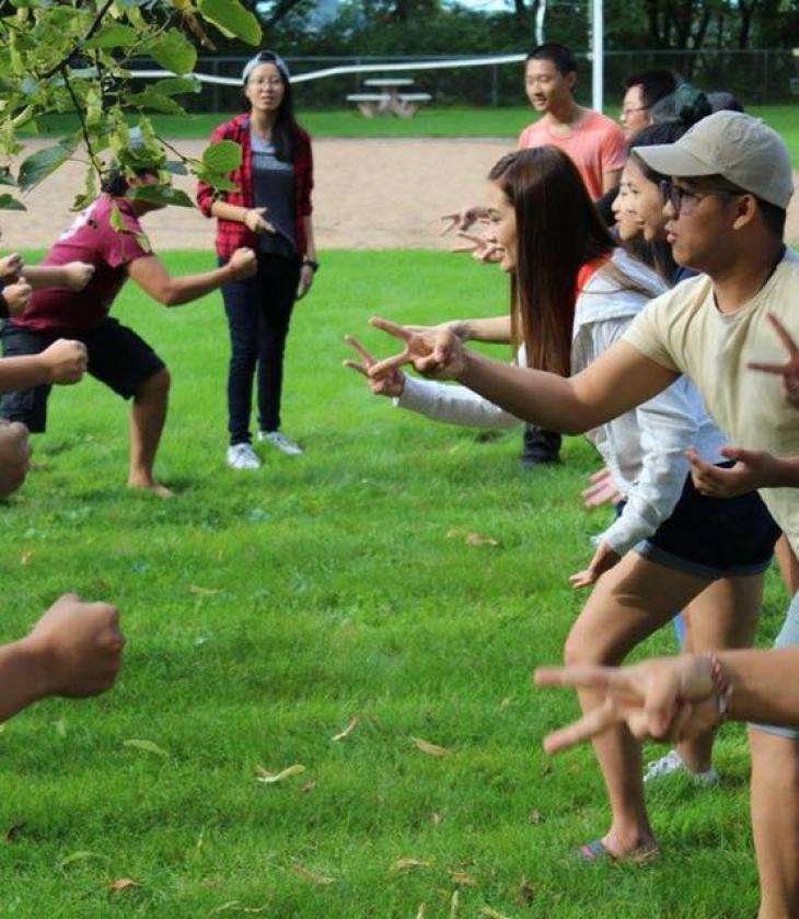 Students in the Hmong living community working together as a group outside