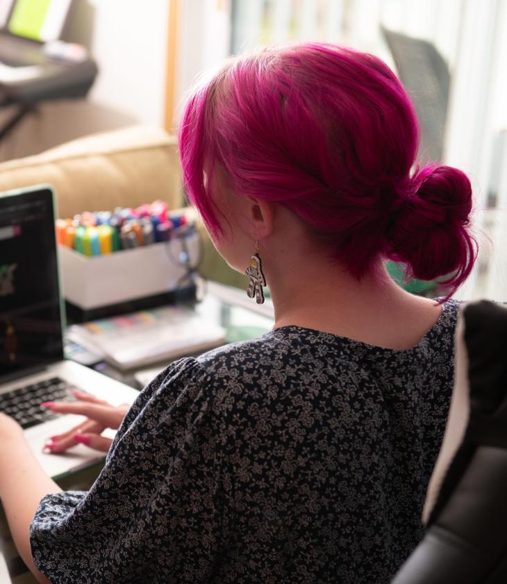 Student works at their computer in their dorm room.