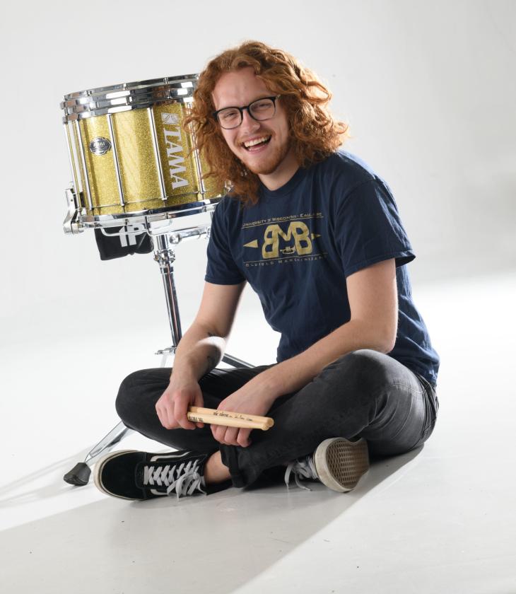 Andrew Smits in studio with drum drums and sticks stick