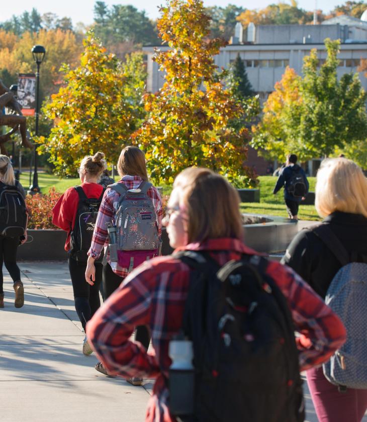 Students in the campus mall walk to class during the Fall.