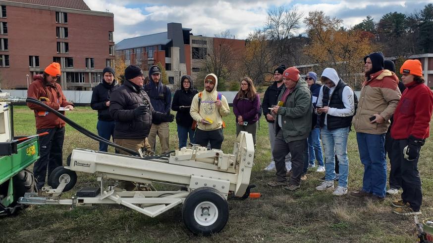 students in geology using core sampling machine