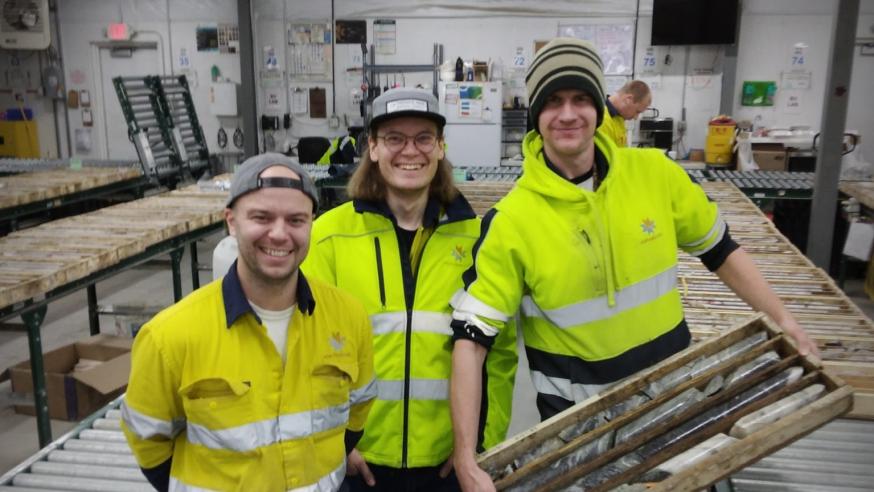 three male geology alumni at shared workplace in mining
