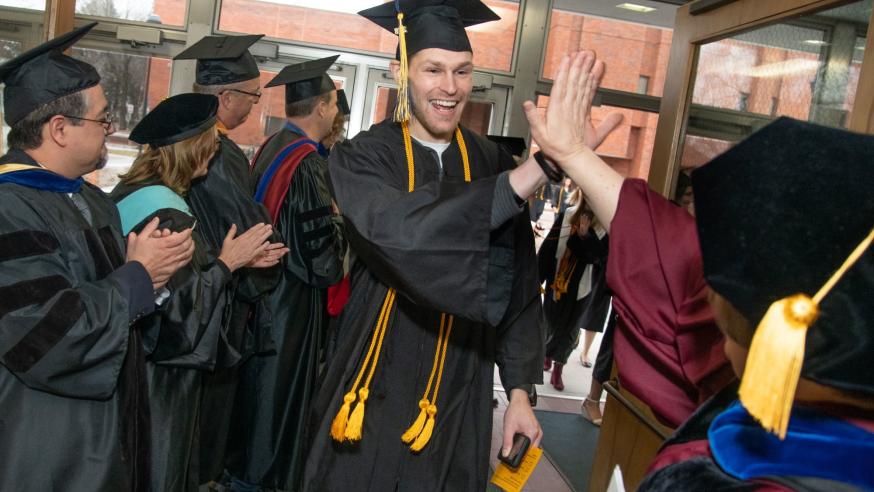 High fives for Dean Manning from male COEHS grad