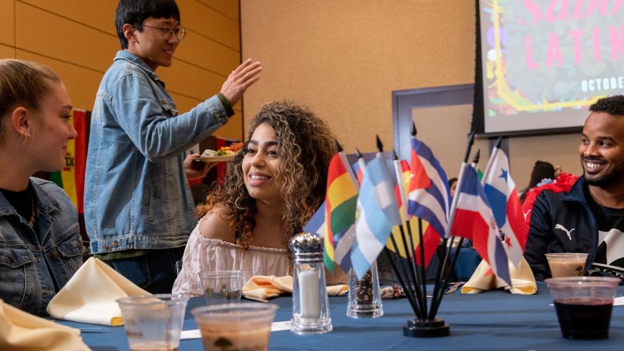 students a LAS week event at a table with Latin American mini flags