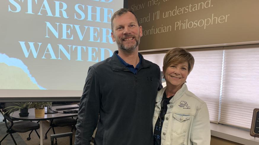 Man and woman pose for a photo in the Center for Excellence in Teaching and Learning