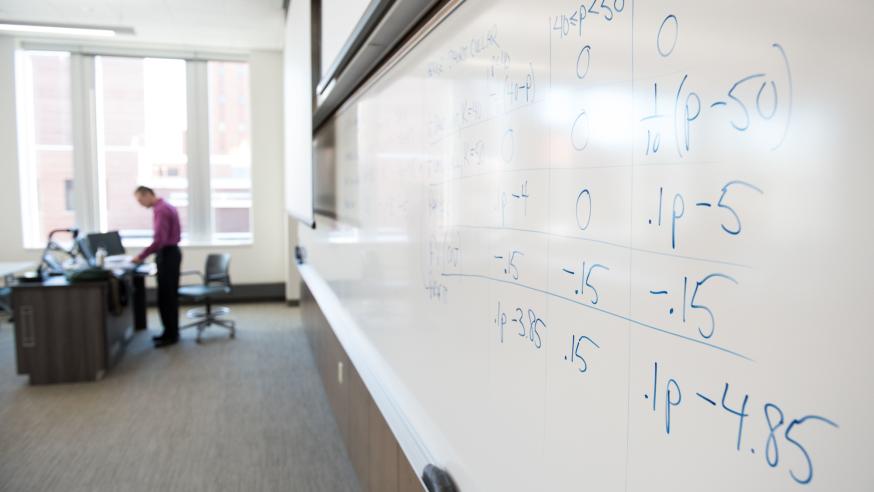 A professor and a math board. A professor and a math board.