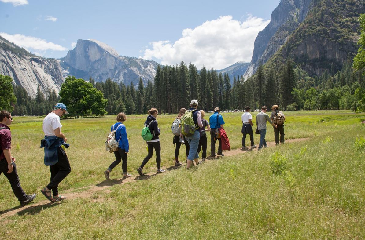 students walking a trial in a valley of Yosemite National Park 