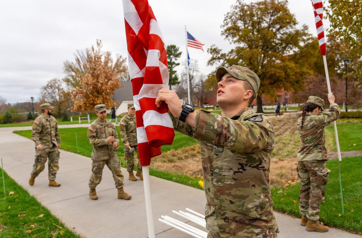 ROTC students raising flags on campus mall for Veterans Day 