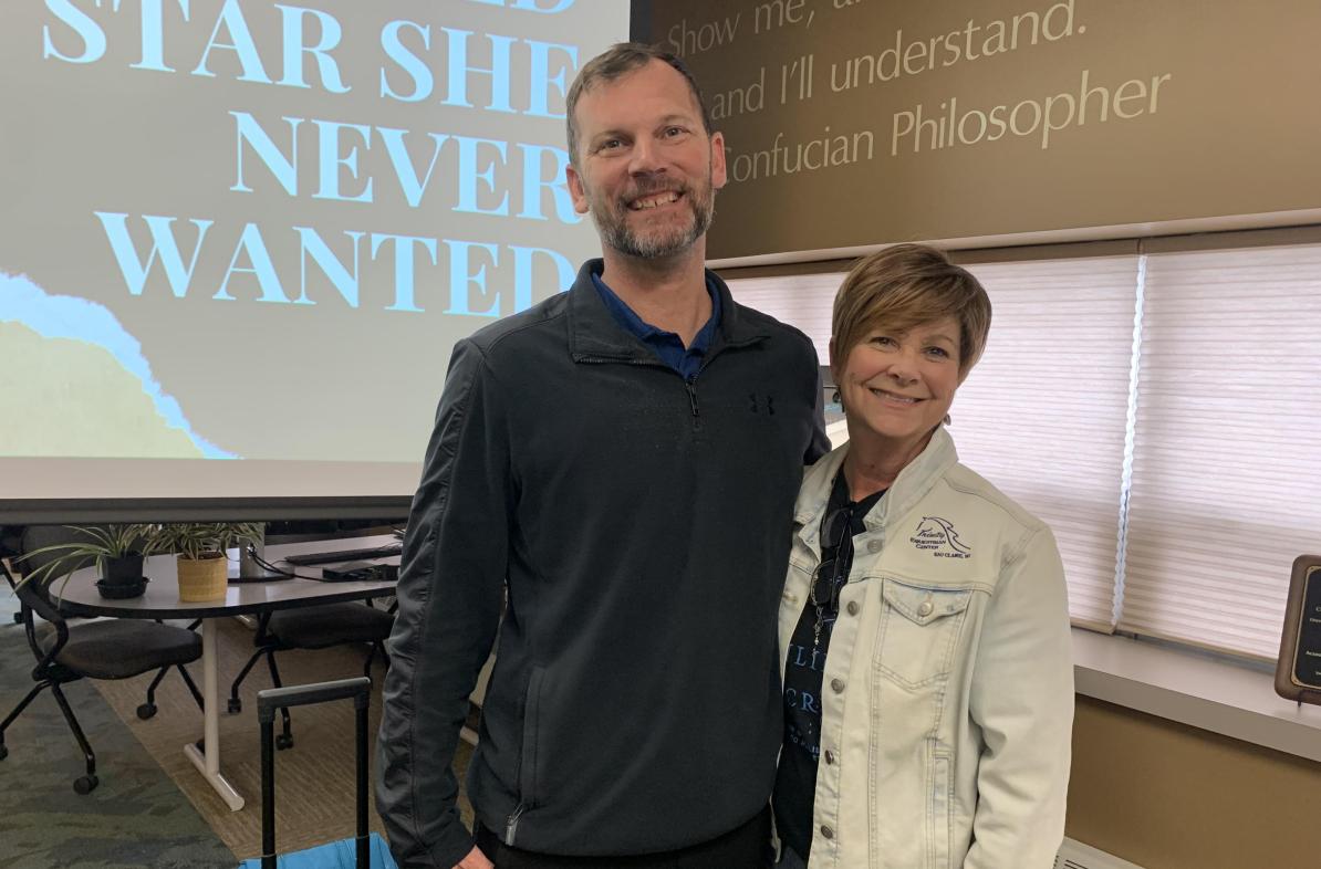 Man and woman pose for a photo in the Center for Excellence in Teaching and Learning