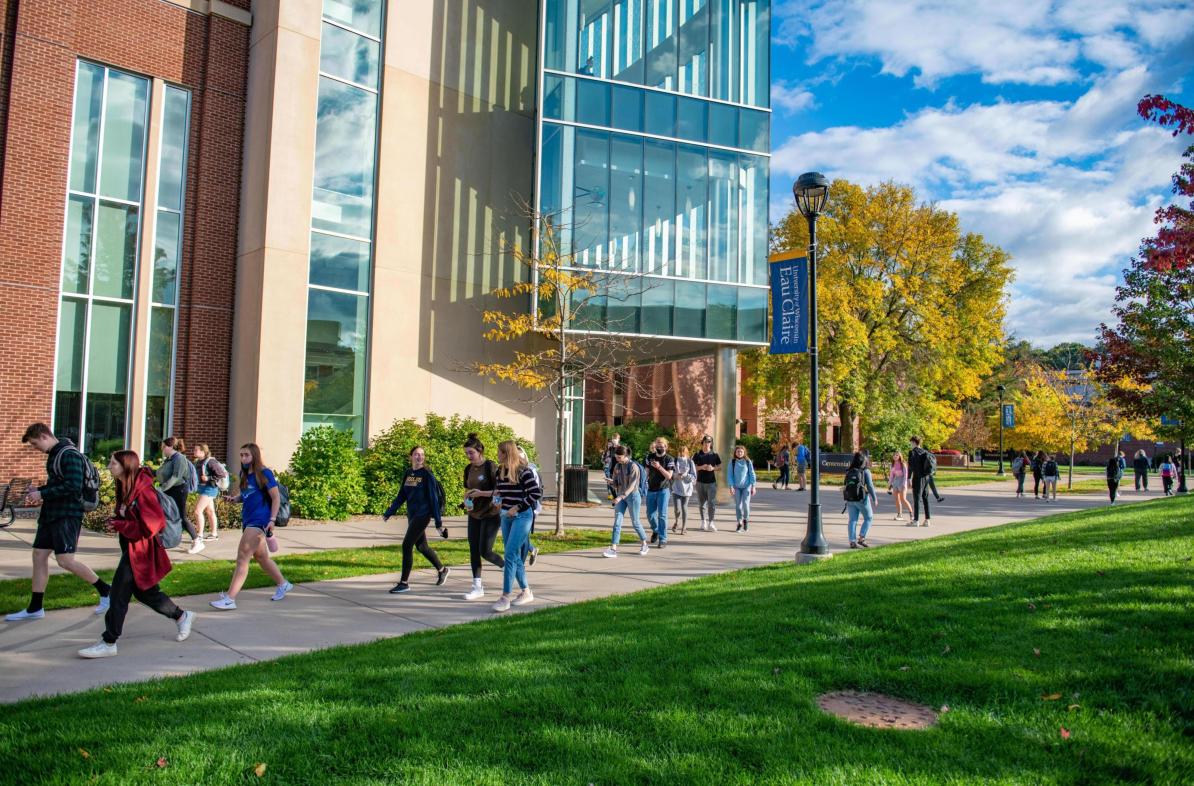 Students passing between classes sunny fall day near Centennial Hall 