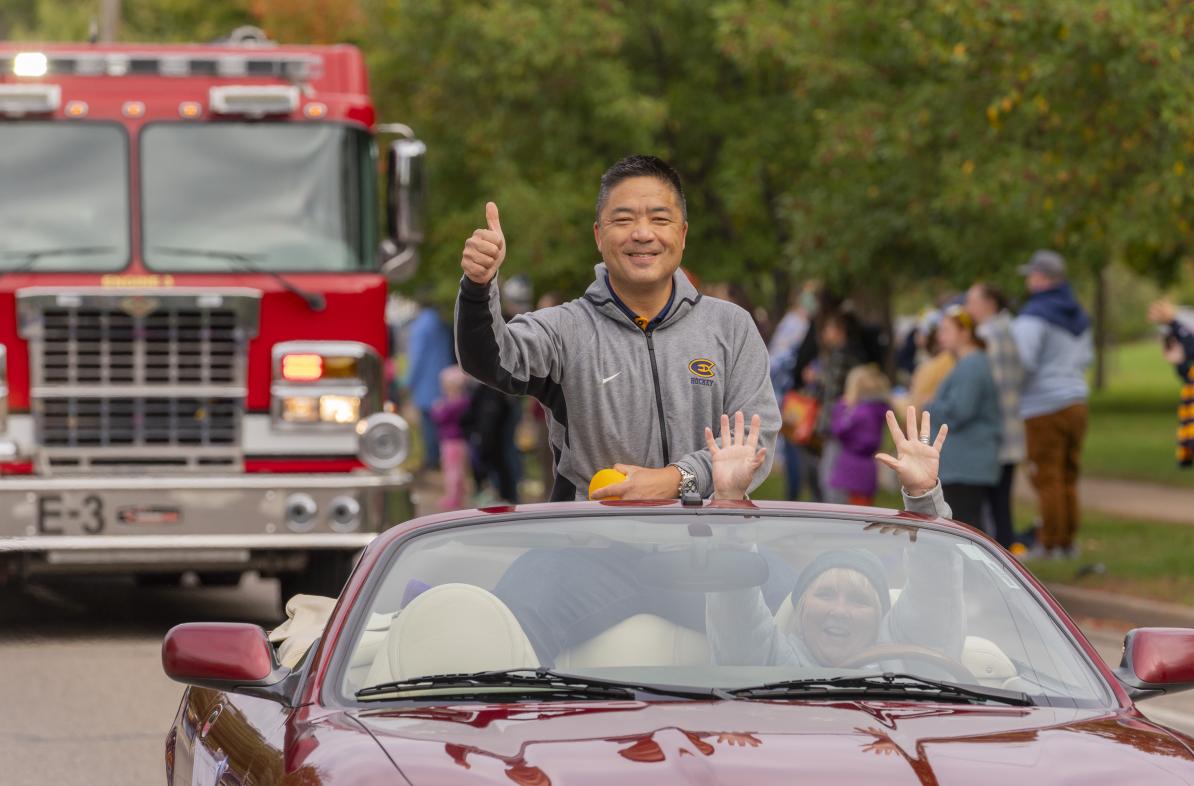 Eric Wan in a red car for 2023 Homecoming Parade 