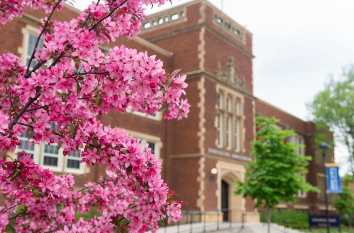 Schofield Hall in the spring with trees blooming.