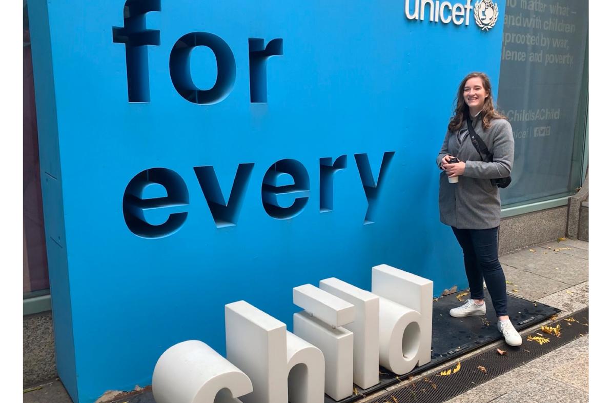 UW-Eau Claire student Kristina Tlusty stands in front of UNICEF sign