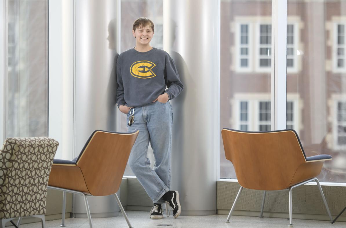 student standing in windows in Centennial Hall