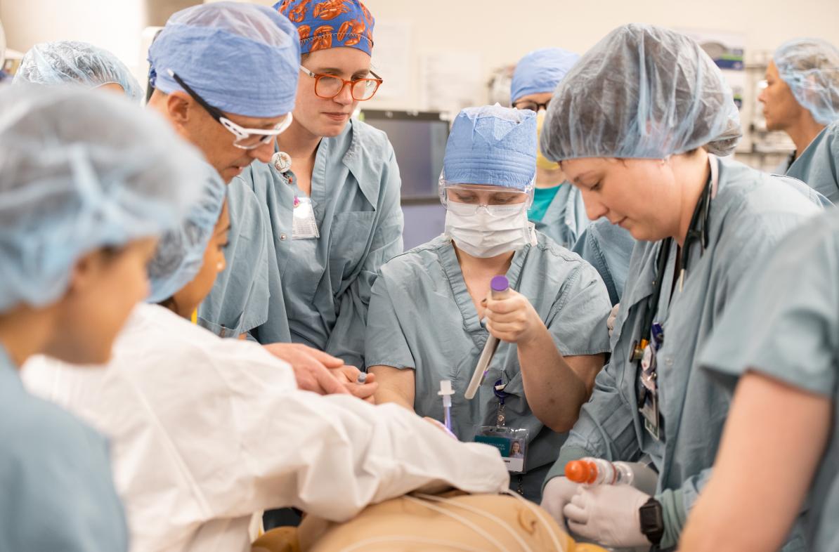 group of medical providers in full scrubs, simulation of code blue