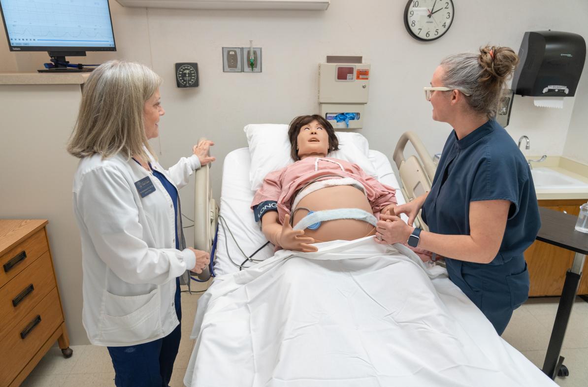 Nursing faculty work with new simulation manikin