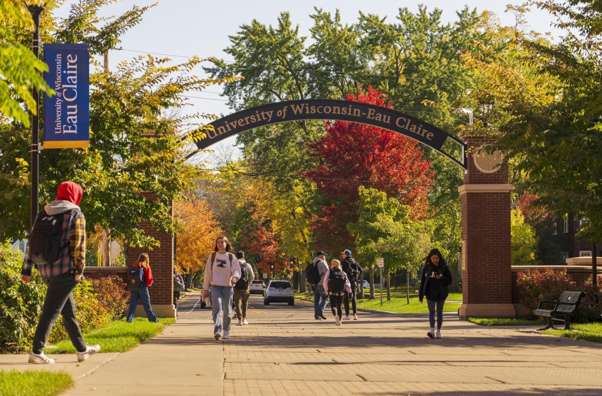 students under the archway at UWEC, fall scene