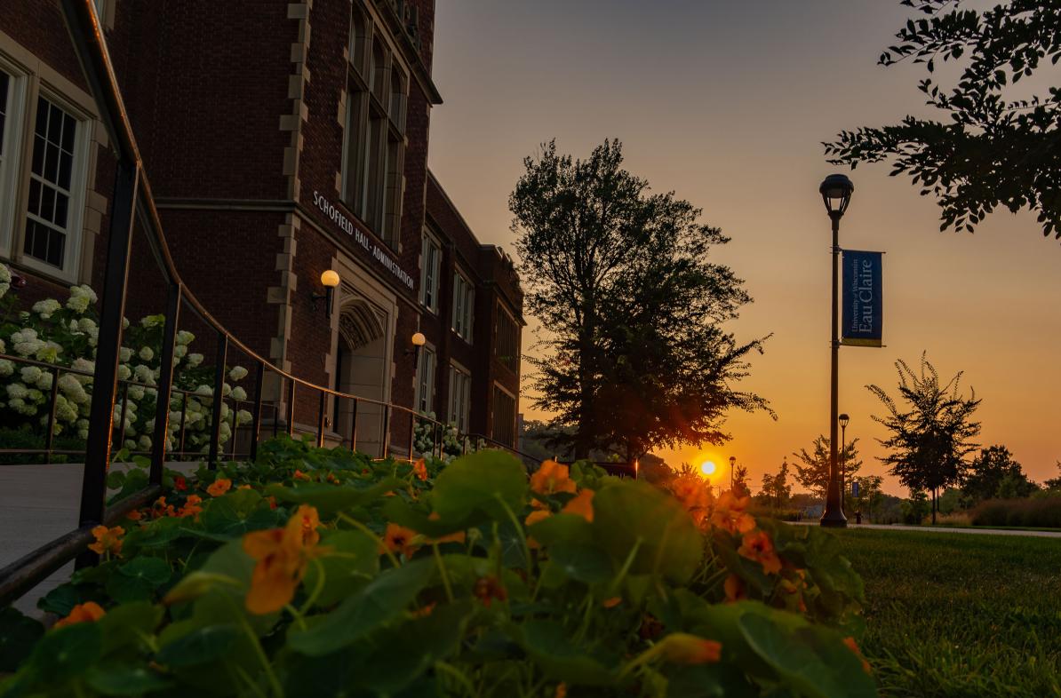 sunset over summer flower pot in front of Schofield Hall