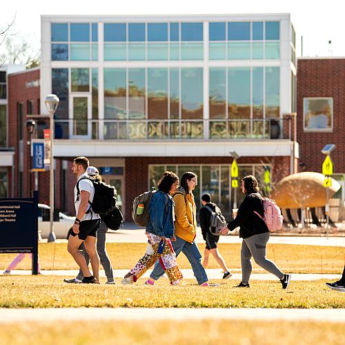 campus scene fall , students passing on the mall